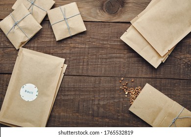 Paper bags with seeds for planting. Wooden table. View from above. - Shutterstock ID 1765532819
