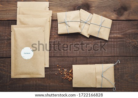 Paper bags with seeds for planting. Wooden table. View from above.