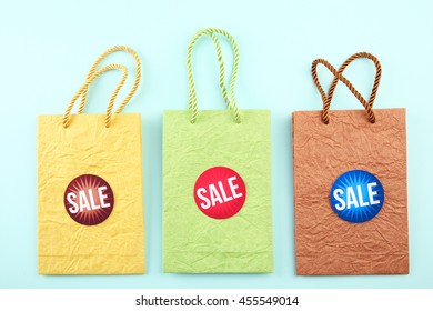 Paper bags with word sale on blue background - Powered by Shutterstock