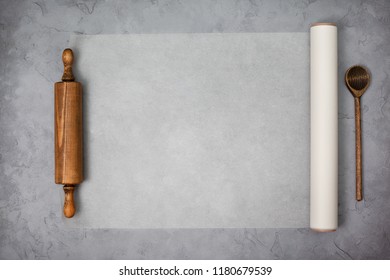 Paper For Baking, Wooden Rolling Pin On A Gray Concrete Background. View From Above. Copy Space