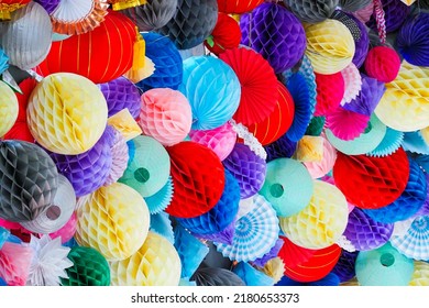 Paper balls background. Multicolored paper pom-poms or honeycomb paper balls for the holiday decoration.