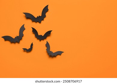 Paper bats for Halloween party on orange background - Powered by Shutterstock