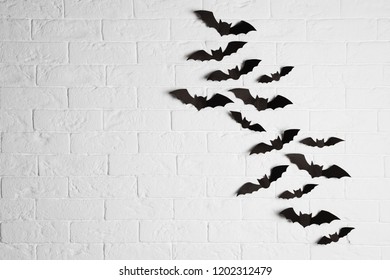 Paper Bats On Brick Wall With Space For Text. Halloween Decor