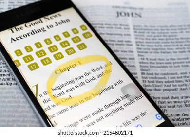 Paper Bible and digital Bible app on smartphone.  The New Testament. Gospel. John.  07-30-2018