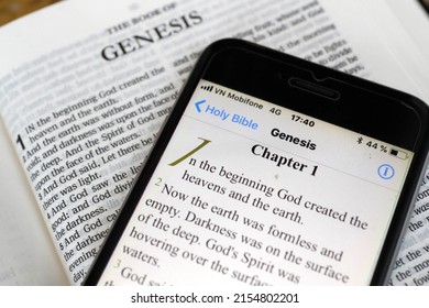 Paper Bible And Digital Bible App On Smartphone.  The Old Testament. Genesis.  07-30-2018