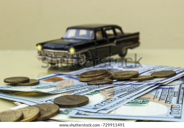 Paper bills and small things on the background of\
the car.