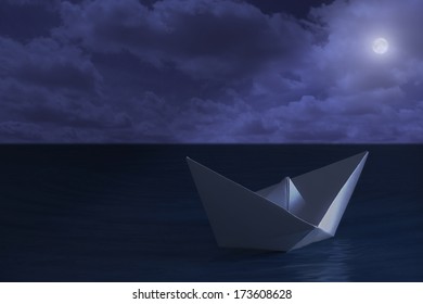  Paper boat floating in the sea at night  - Powered by Shutterstock