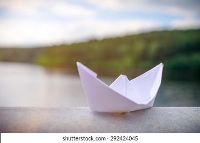 A Paper Boat On A Railing In Summer