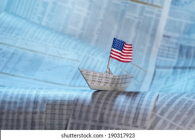 Paper Boat With US Flag Shipping On Financial News.