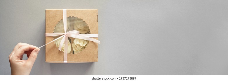 Paper Box With Cream Cupcake. Birthday Sweet Bakery. Cookies Four Pack. Yummy Buttercream Dessert. Wedding Party Food. Grey Background. Holiday Recipe. Hand Holding