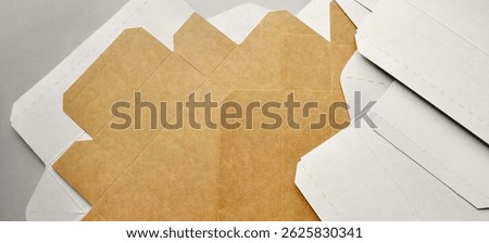 Paper box sheets. Opened cardboard boxes. Cardboard box layers background. Monochrome background, copy space. Sustainable packaging, artistic background. Transportation, packaging materials