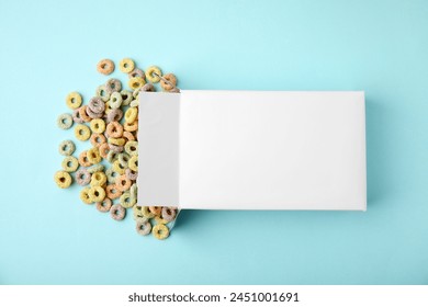 Paper box with tasty cereal rings on light blue background, flat lay - Powered by Shutterstock