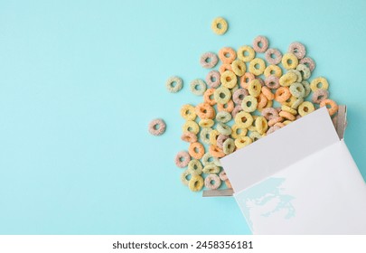 Paper box with tasty cereal rings on light blue background, flat lay. Space for text - Powered by Shutterstock