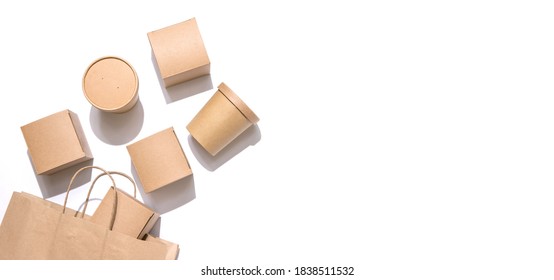 Paper Boxes For Food And Drinks Drop Out Of The Craft Bag. White Background, Top View. Copy Space. Delivery, Take Away, To Go, Eco-friendly, Package Concept. Nobody.