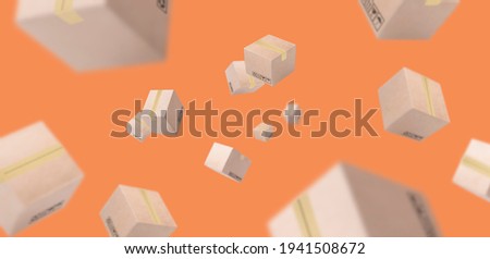 paper boxes parcel falling and flying on orang  background. concept shopping online and service home delivery.