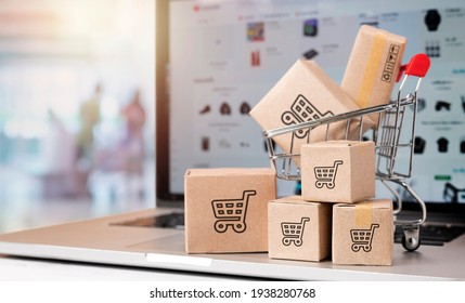 paper boxes parcel in a trolley on laptop in shopping mall. concept shopping online and service home delivery.black friday concept - Shutterstock ID 1938280768