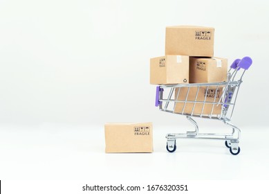 Paper boxes in a trolley on white background.Online shopping or ecommmerce concept