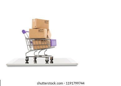 Paper boxes in a trolley with tablet on white background,Online shopping or ecommmerce concept
