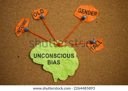 Paper brain pinned pined to the board. Unconscious bias concept.