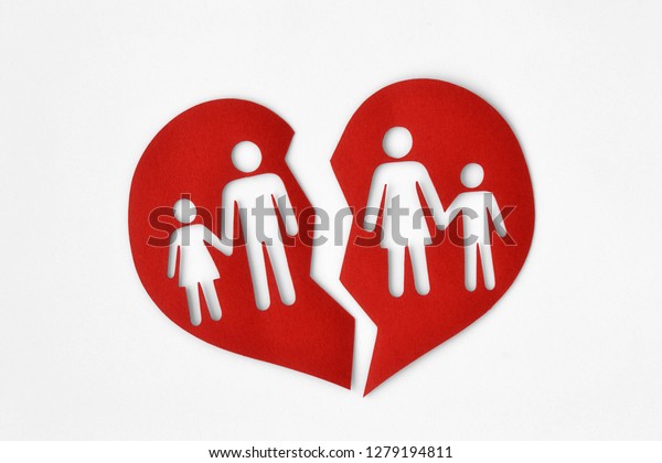 Paper broken heart with a family - Divorce and\
broken family concept