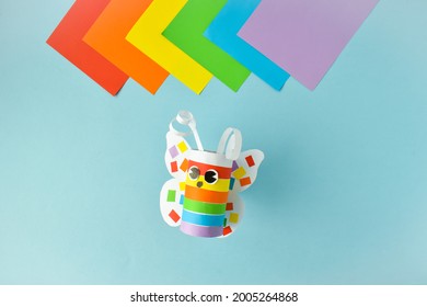 A paper butterfly made of colored paper. Step-by-step instructions for LGBT characters. Step 3. Glue and twist. The butterfly is ready.