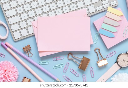 Paper Card,  Pink School Accessories And Keyboard On Light Blue , Top View, Mockup. Girly Workplace With Notebook, Scissors, Pencil, Pen, Paperclips, Cards And Watch. Back To School 