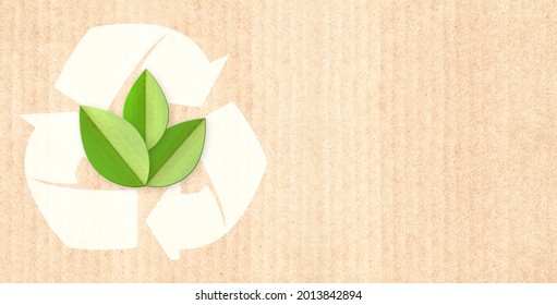 Paper Cardboard Background With Green Leaves  In Paper Cut Style And Arrow Recyle Symbol. Horizontal Banner With Eco Paper Texture. Recycled Carton Material. Copy Space For Text. Mock Up Template