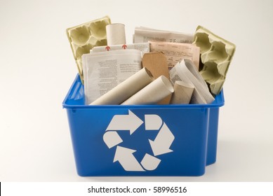 Paper And Cardboard In A Blue Recycling Bin. White Background.