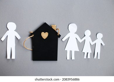 Paper Chain Cut Family Near Toy House On Gray Background. Divorce And Broken Family Concept.