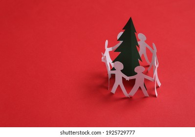 Paper Chain Cutted People Around Christmas Tree On Red Background