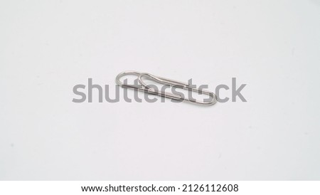Paper clip. Metal steel clip for documents and paperwork in office, on white isolated background. Business and contract.