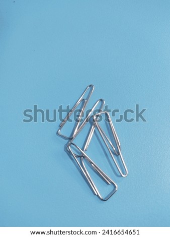 Paper Clip on the Blue Table in the office 