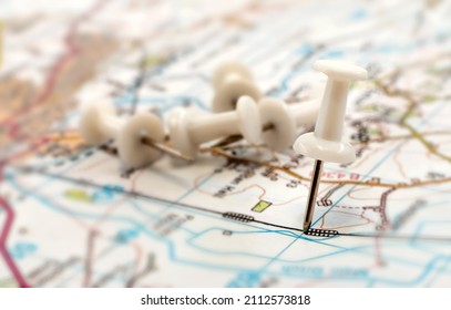 A Paper Clip On The Map Shows The End Point Of The Route. Travel Guide. Map Of The City, Area