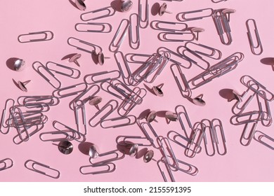 Paper Clips And Buttons Are Scattered On A Pink Background.  School Supplies.  Advertisement For Stationery.  Card.  View From Above