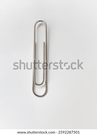 Paper clips are used to bind sheets of paper. metal paper clip isolated on white background