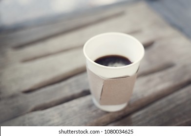 Paper Coffee Cup With Brown Clubboard On Wooden Table. It Look Inexpensive. Cheap Coffee.