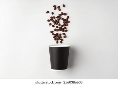 A paper coffee cup surrounded by freshly roasted coffee beans on a clean white background - Powered by Shutterstock