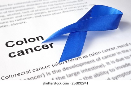 Paper With Colon Cancer And Dark Blue Ribbon.  