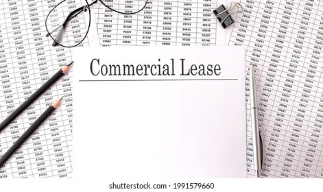 Paper With Commercial Lease On A Table With Chart