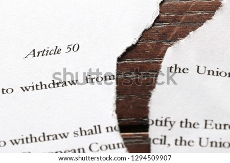 Paper copy of article 50 ripped in two. Close up view showing some genuine text of article 50 of the Lisbon treaty. Represents Brexit arguments over extending or revoking UK leaving the EU