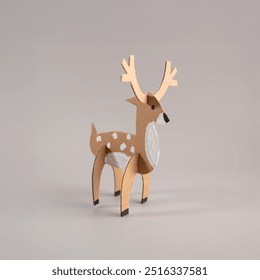 Paper craft deer model in 3D, brown with white spots, antlers prominent, facing right on a grey background, inspiring craft project for animal model enthusiasts, creative paper art, recycle concept - Powered by Shutterstock - Get 15% off with code: PIKWIZARD15