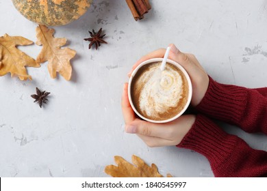 Paper Cup With Delicious Pumpkin Latte With Spices In Female Hands On A Gray Table. View From Above. With Place For Text.