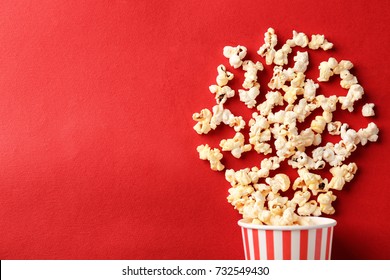 Paper cup with popcorn on color background - Shutterstock ID 732549430