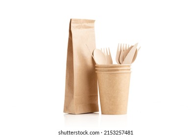 Paper cups and paper bag made of eco kraft paper. Wooden cutlery set. Recycling concept. Zero waste.