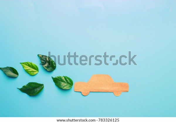 Paper cut\
of car on blue background. eco car\
concept