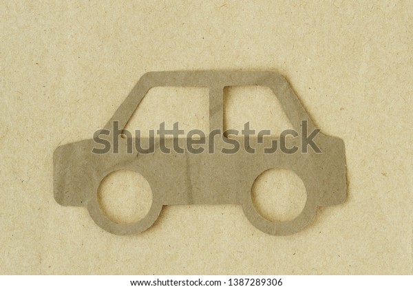 Paper cut of car on recycled paper background -\
Eco-friendly car concept