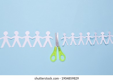 Paper Cut Chain Of People With Scissors On Blue Background