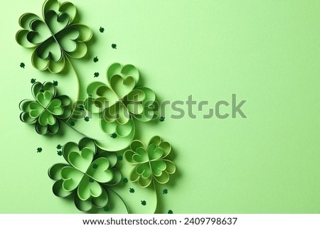 Paper cut clover and confetti on green background. Happy St Patrick's Day concept.