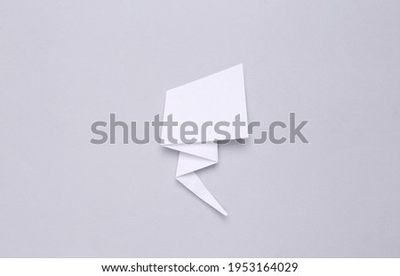 Paper cut comic dialog cloud on gray background. Copy space