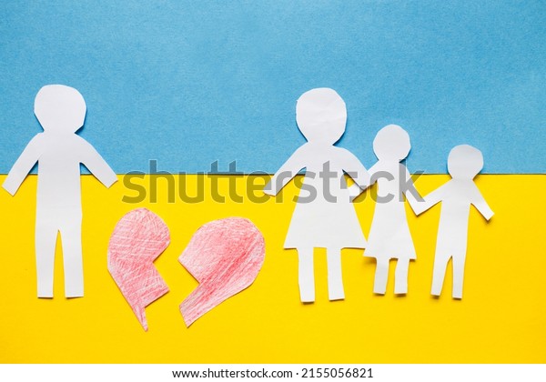 paper cut divided family on the background\
of the ukrainian flag. stop war\
concept.